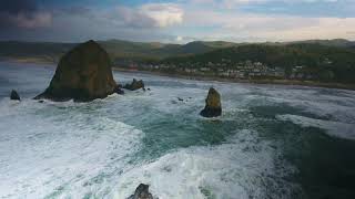 Aerial Drone Shot Of Haystack Rock Going To The Coast In 4K