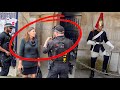 Armed officers confronts a lady and kings guards has had enough for one day and shouts