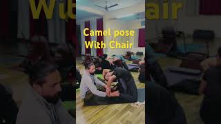 residential yoga school in Rishikesh ( camel pose with chair)