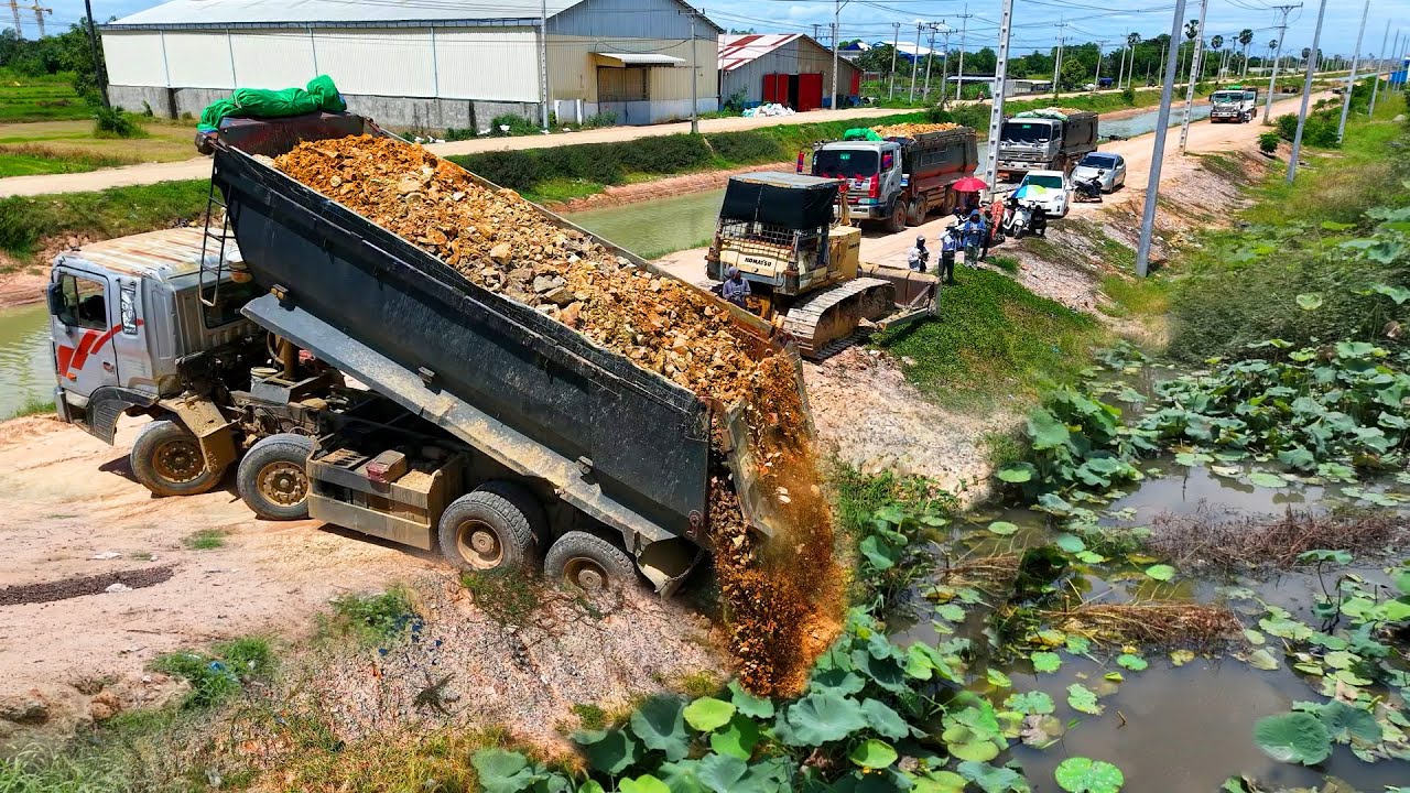 Heavy equipment, Full Processing Filling Up The Land, Bulldozer KOMATSU D60P, Dump Truck unloading