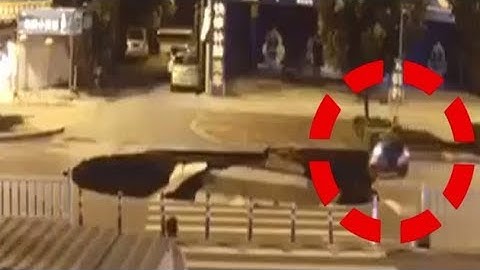 Watch: A man on a scooter drives straight into a huge sinkhole