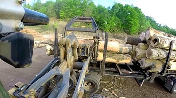 Unloading logs..  John Deere 544J