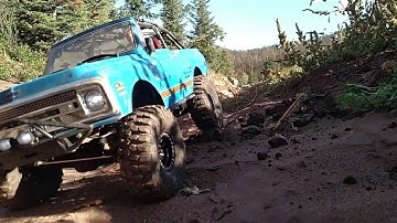 Axial scx10 II Blazer and Axial 1.9 Wraith trailing on sand and rocks.