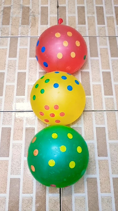 Burst three red, yellow, and green polka dot balloons.