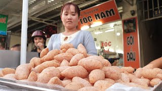 Admired, her sister made a very fast 'tiny' yam cake on Saigon sidewalk Admired, her sister made a very fast 'tiny' yam cake on Saigon sidewalk