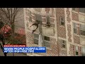 People dangle out of homes awaiting rescue from South Shore high rise fire