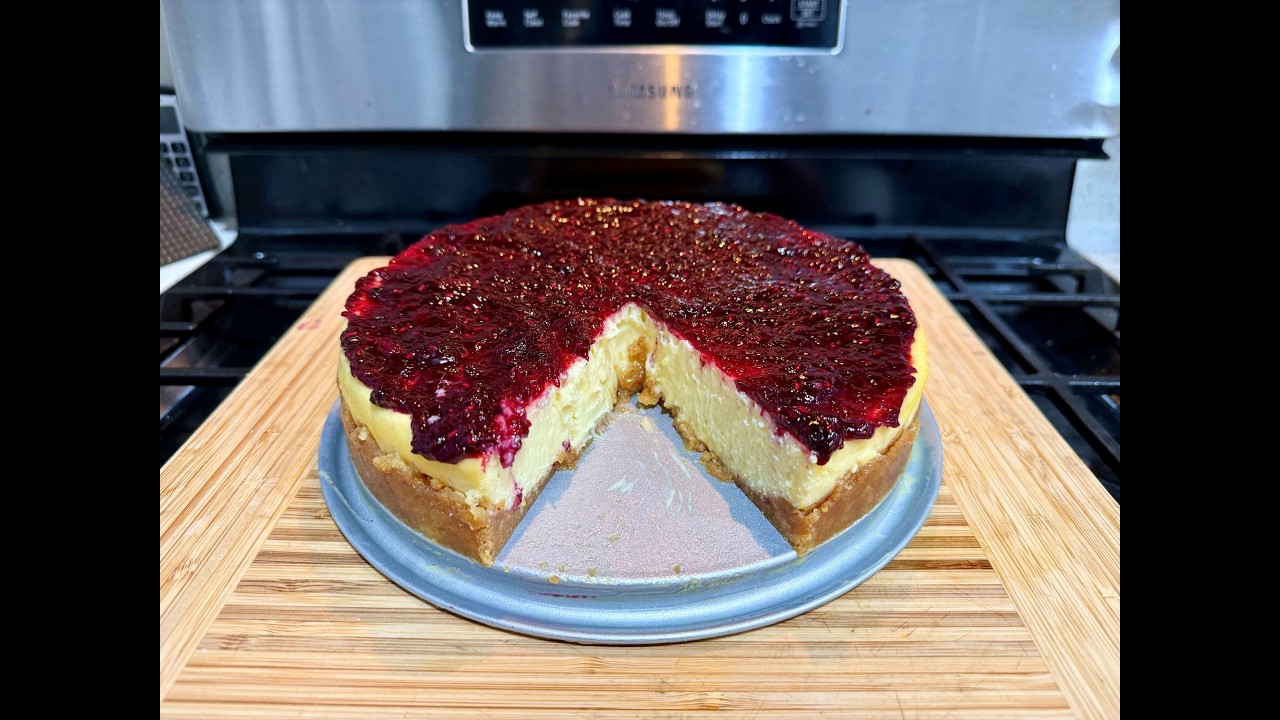 White Chocolate Lemon Cheesecake with Biscoff Cookie Crust and Mixed Berry Compote