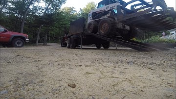 Loading bobcat into dump trailer
