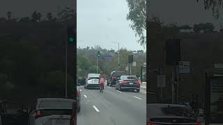 Girl Tries Hitting a Car with Her Hand at a Traffic Light