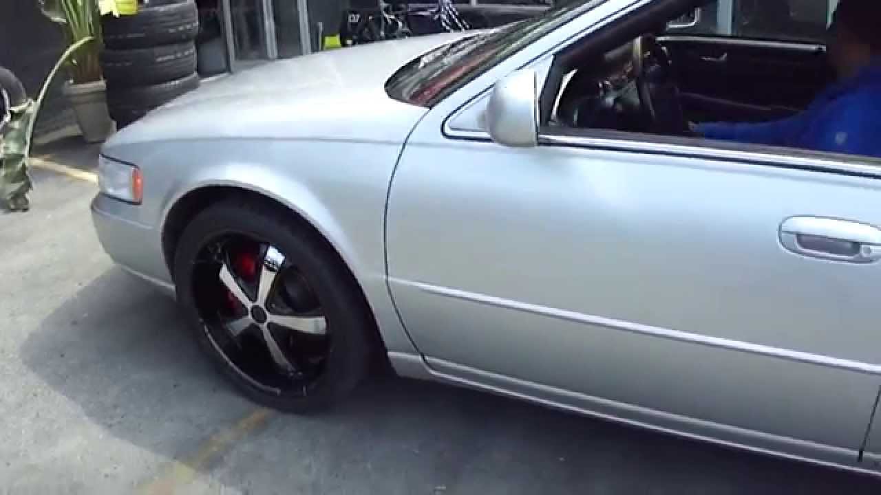 HILLYARD CUSTOM RIM&TIRE CADILLAC SEVILLE RIDING ON 20" BLACK &CHOROME WHEELS