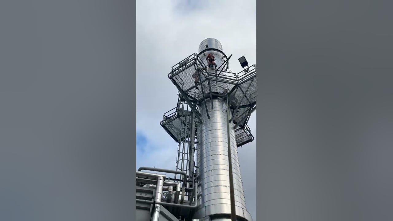 Steeplejack taking ladders down off a small stack steeplejack work 