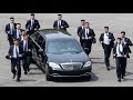 Kim jonguns bodyguards jog alongside limo