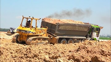 Extremely Spread Dirt Safety Group Overload Trucks Operator With Bulldozer Pushing