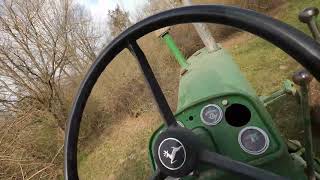 A 730 John Deere takes a leisurely stroll through the woods.