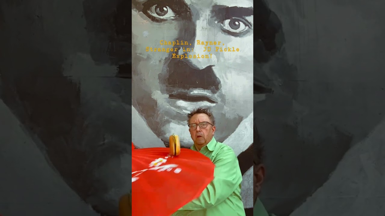 Charlie Chaplin, me and stranger enjoy pickles leaving a cheeseburger.  