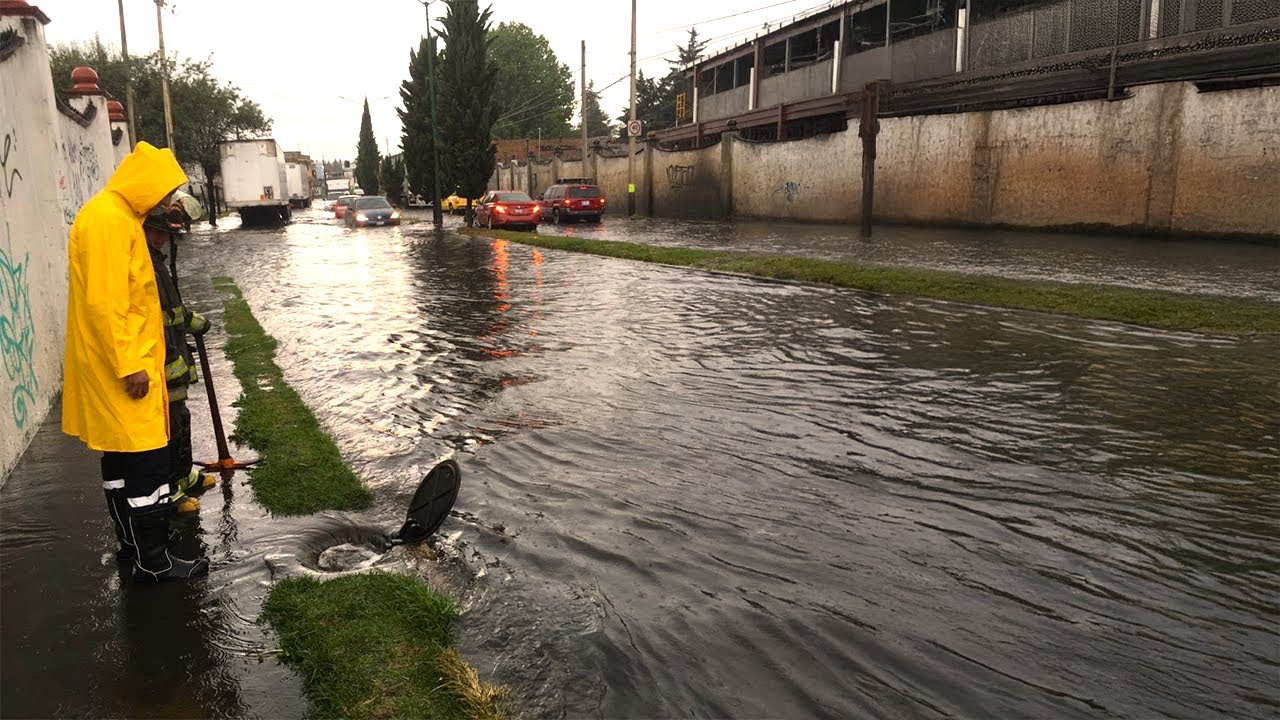 Weather Warrior Clearing Drains in the Storm to Save Flooded Streets ...