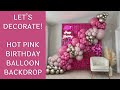 Try this hot pink balloon backdrop idea