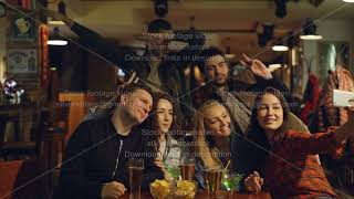 Happy young people in casual clothes are taking selfie in bar. They are posing, making silly faces screenshot 5