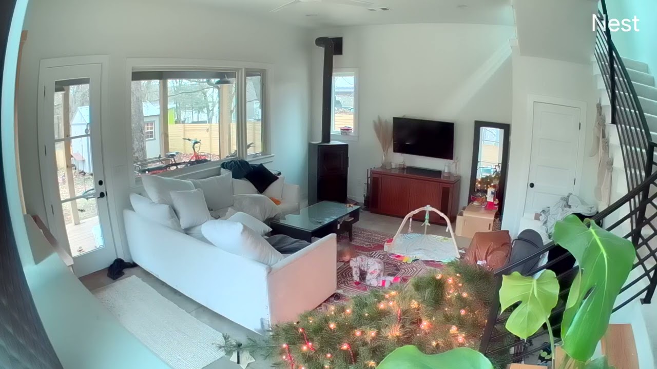 Little boy pulls lights on Christmas tree and falls on his in living room (Security camera)