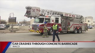 Car crashes through concrete barricade in Waco