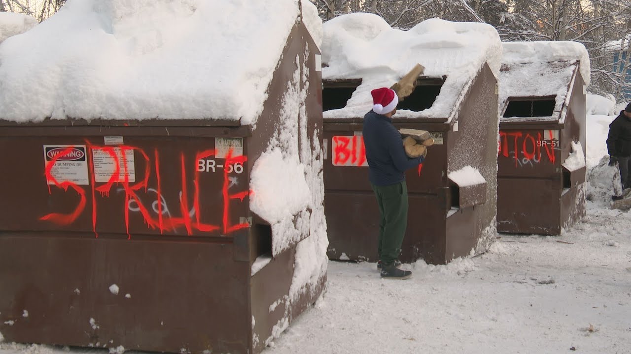 Volunteers stockpile split wood for veteran winter preparedness program in the Mat-Su
