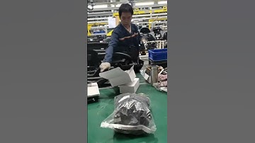 Auto parts factory workers assemble auto parts like this