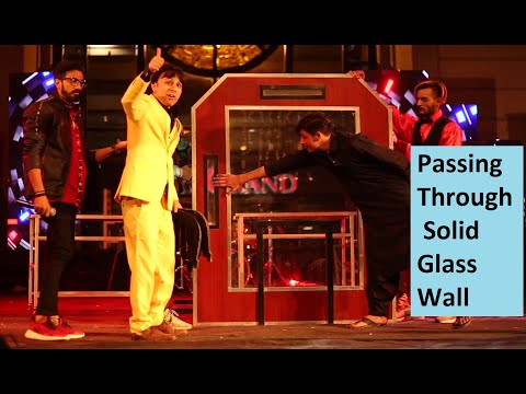 passing-through-solid-glass-wall-illusion-under-audience-inspection,-illusionist-munawar-khan