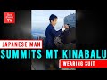 Japanese man summits Mt Kinabalu wearing suit