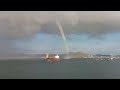 Waterspout flies past ships