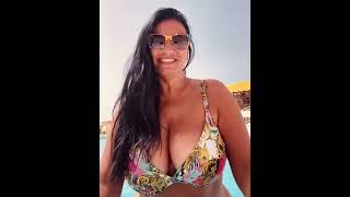 Busty Mature Brunette Bikini blows a kiss by the pool