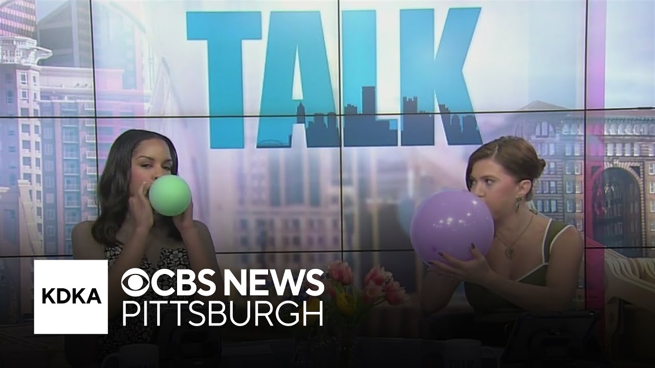 Heather and Mikey practice balloon-tying skills