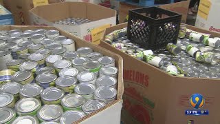 Volunteers pack boxes of food to feed more than 3,000 families for Thanksgiving