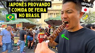 Japonês provando comida de feira no Brasil