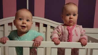 Twins standing in their cribs!