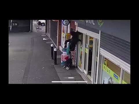 Going up?: Hilarious moment elderly woman is unexpectedly lifted up by shop shutters