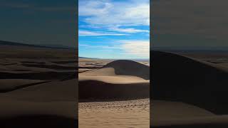 Sand Dunes and Mountains? Where do you think this is? #travel #sanddunes #mountains #shorts