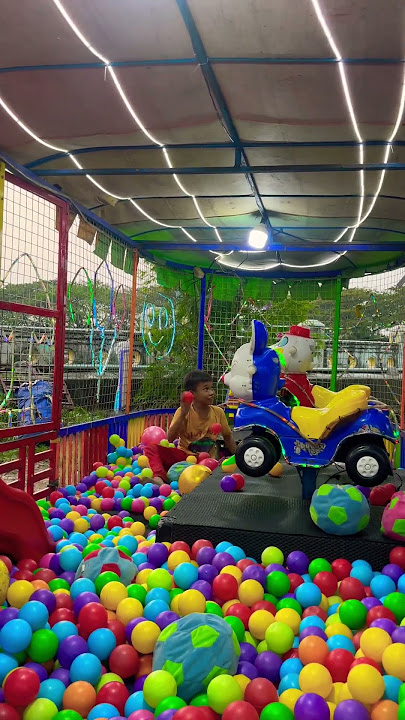 The kid in the yellow shirt plays alone in the ball pool, it's fun