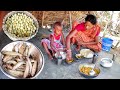 santali tribe mother cooking small fish curry with mohua wine flower recipe for her little girl