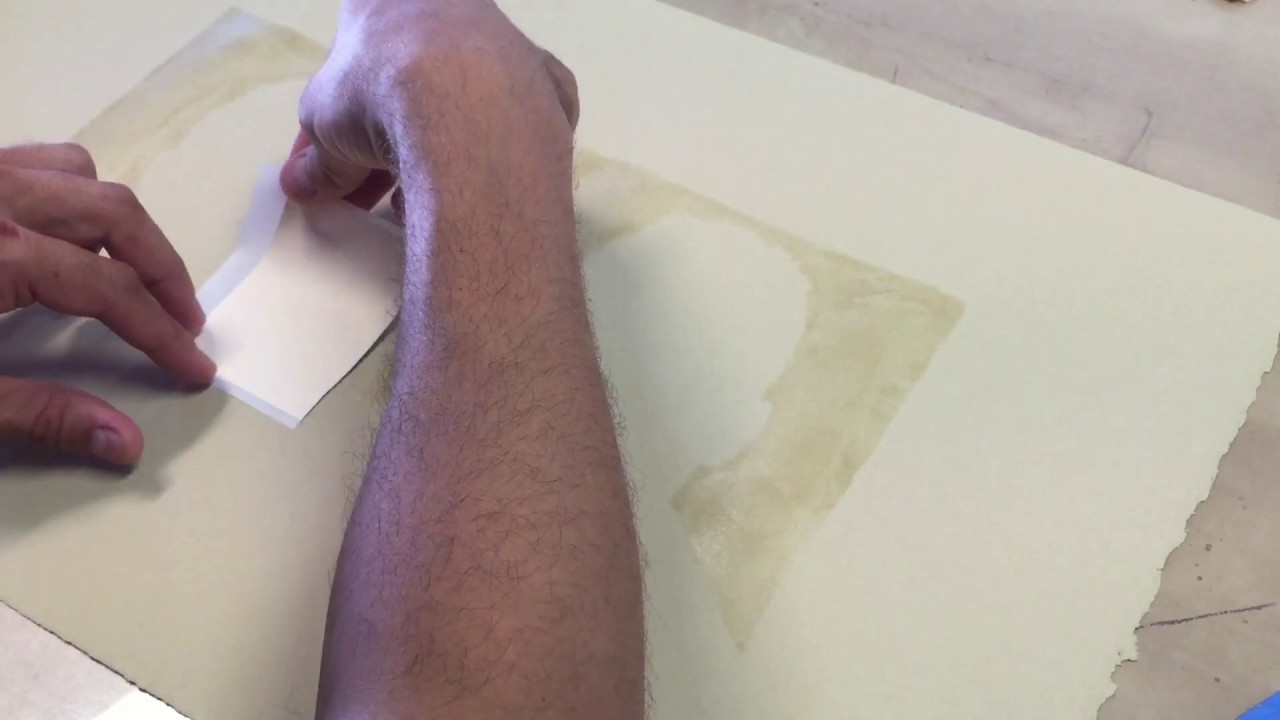 applying gold leaf to paper