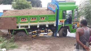 Ashok Leyland tipper lorry stuck in the mud and jcb operator push the lorry