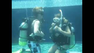 Scuba Diving Couple Exchanging Air In Pool