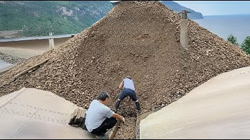 The process of unloading 2,500 tons of phosphate rock from a barge  The process went smoothly