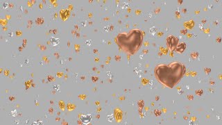 Shiny Gold Silver and Bronze Heart Ornaments Falling In Slow Motion 4K Moving Wallpaper Background