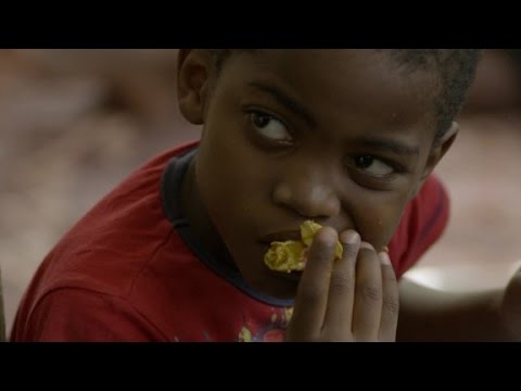 Bourdain learns how to eat Senegal's national dish