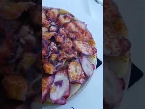 Eating Spanish octopus dish Pulpo a la Gallega MĆLAGA, Spain 20 agosto