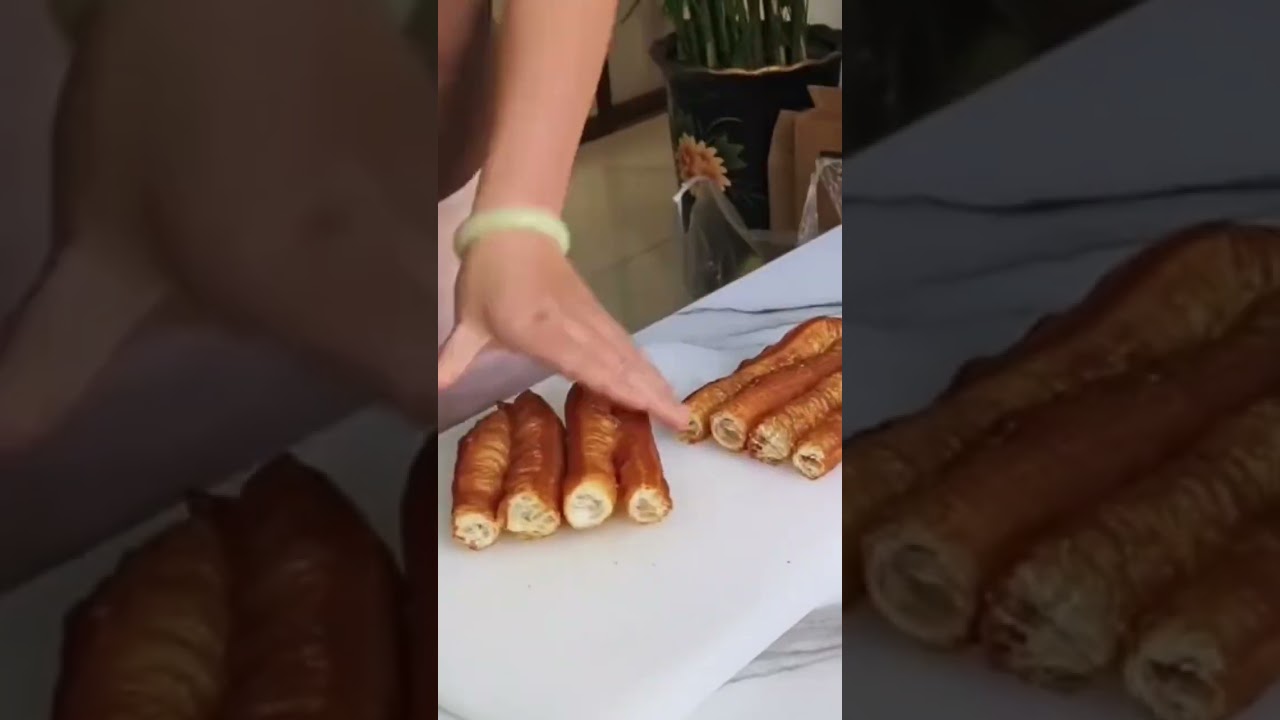 cutting a piece of bread using a knife into several pieces