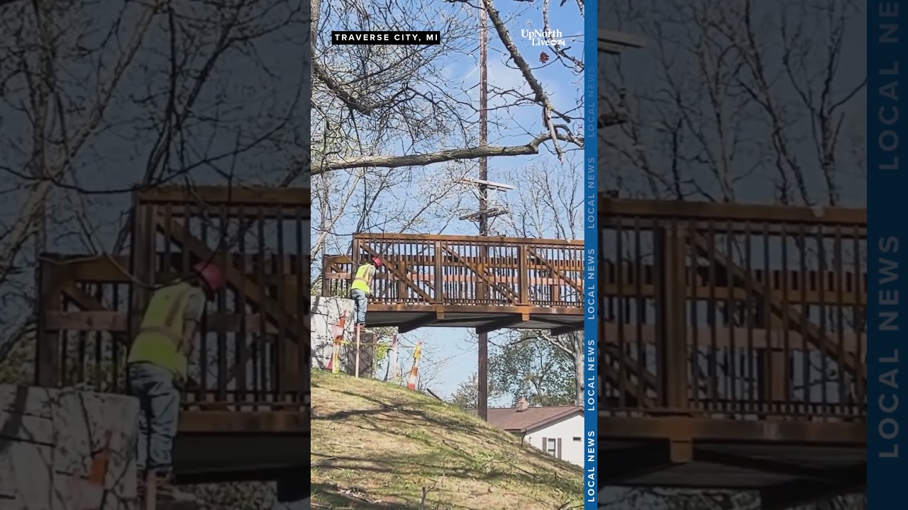 Crane aids installation of Traverse City's new bridge as part of walking track improvement