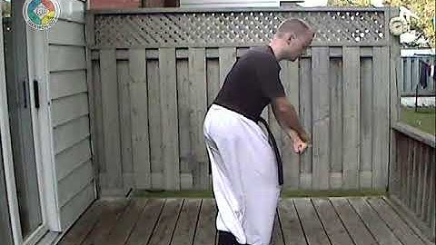 Taekwondo: Hapkido: Foundations: Jumping low x-block in x-stance (front view)