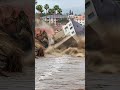 Building on Hillside Tilts into River After Landslide!