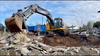 Excavator Removing Concrete and Loading Trucks